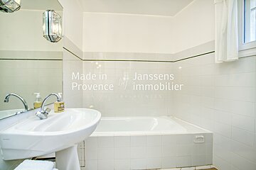 A bathroom with a sink and a bathtub made in provence by immobilier