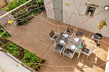 An aerial view of a patio with a table and chairs