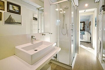 A bathroom with a sink and a walk in shower