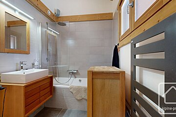 A bathroom with a towel rack and a sign that says alpine-pro