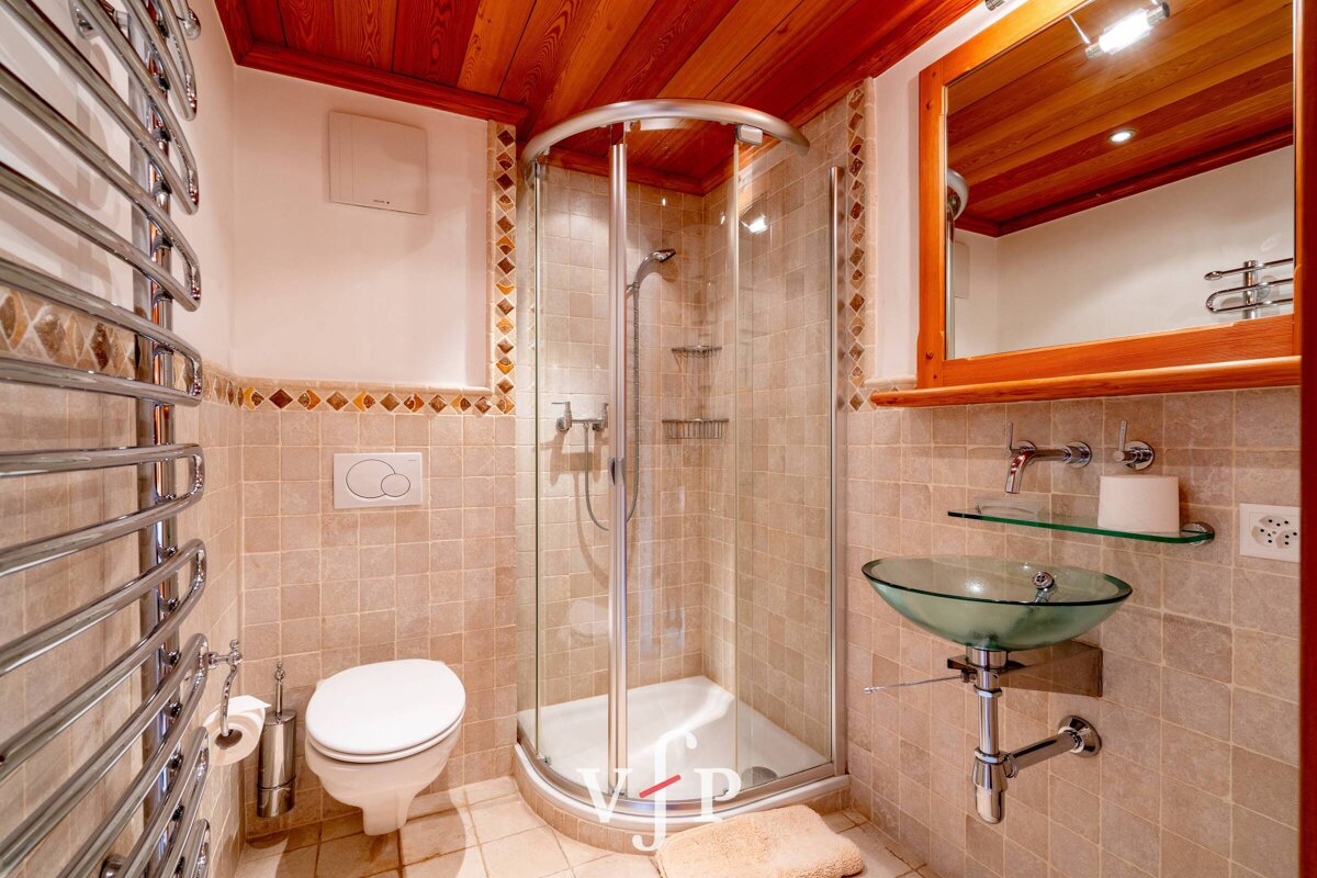 A bathroom with a toilet and a glass sink