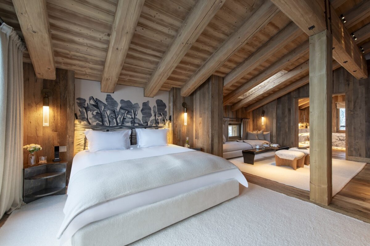 A bedroom with wooden beams and a large bed