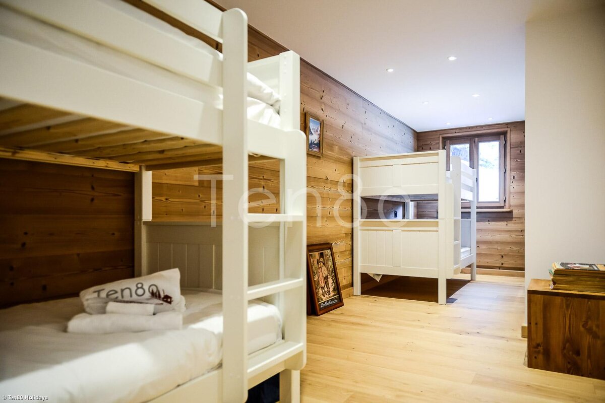 A bunk bed with a pillow that says ten80 on it