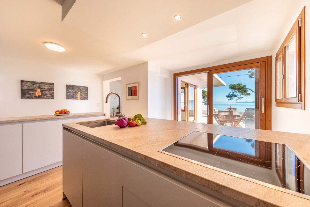 A kitchen with a stove top oven and a sink