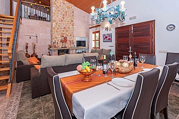 A dining table with a bottle of wine on it