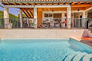 A house with a swimming pool in front of it