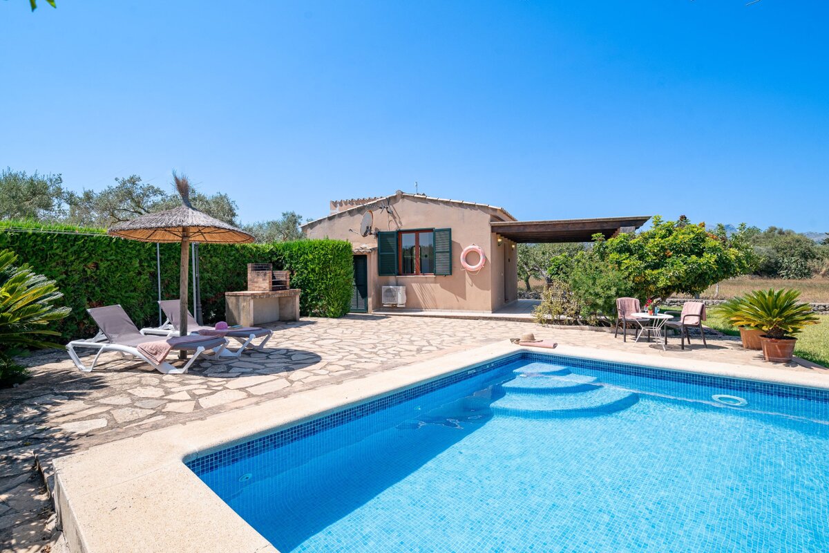 A house with a swimming pool in front of it