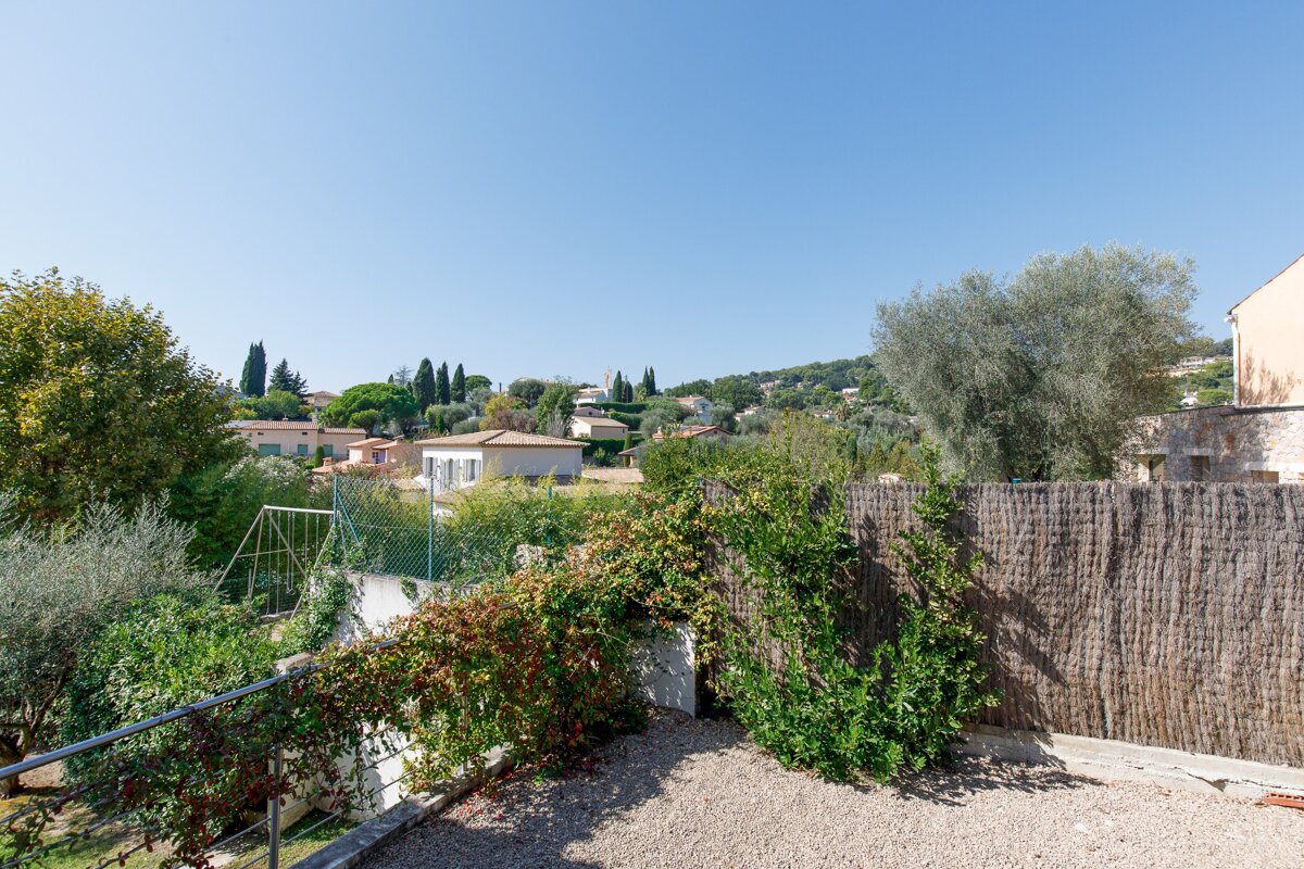 A fenced in area with a view of a small town