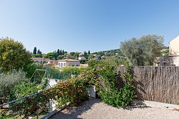 A fenced in area with a view of a small town