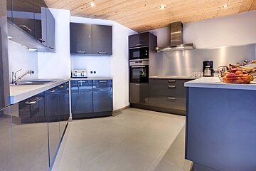 A kitchen with stainless steel appliances and blue cabinets