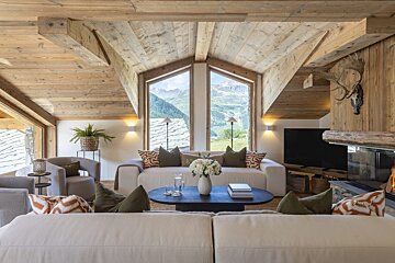A living room with a white couch and a fireplace