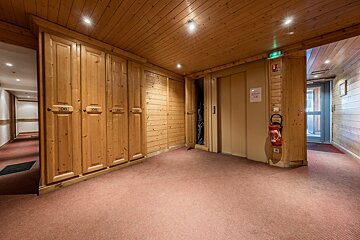 A hallway with wooden cabinets and a fire extinguisher