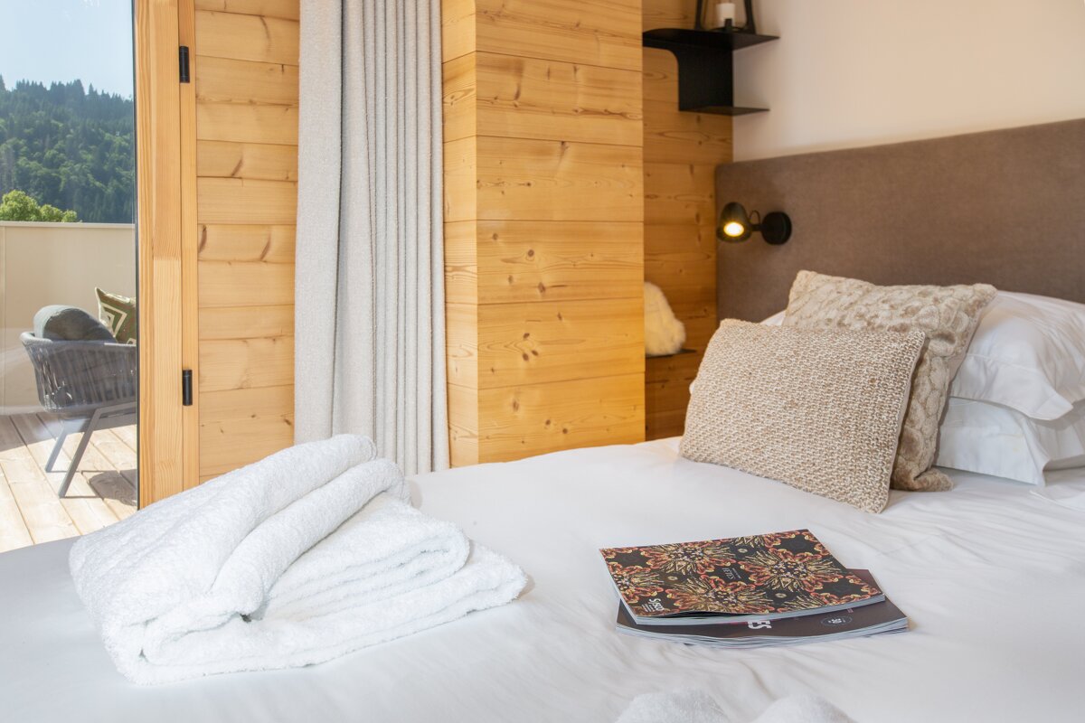 A bed with a magazine and a towel on it