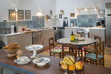 A bottle of wine sits on a table in a kitchen