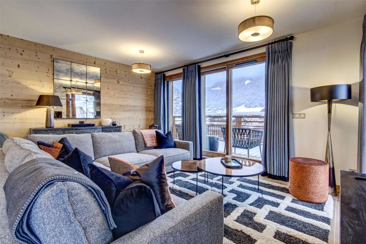 A living room with a couch and two coffee tables