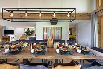 A dining room table with plates of food on it