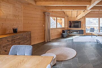 A living room with a couch and a flat screen tv