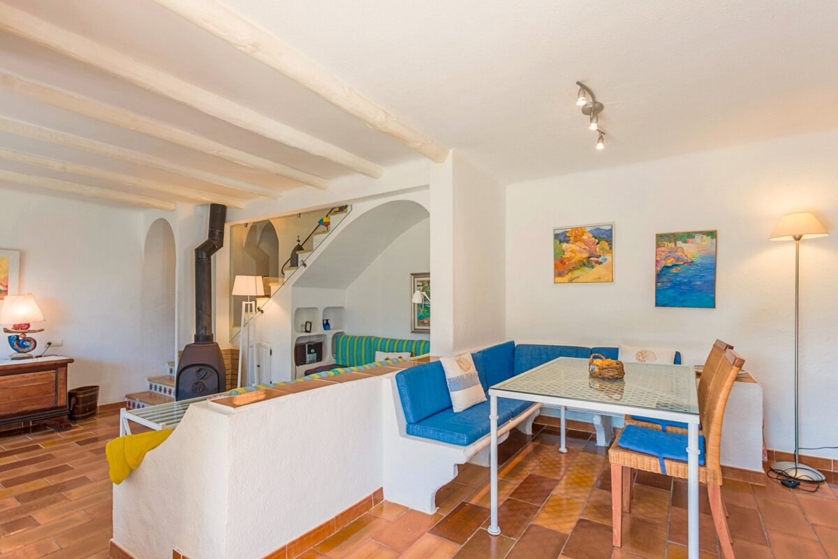 A living room with a table and chairs and a fireplace