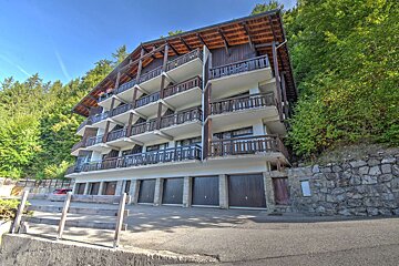 A large building with a lot of balconies and garages