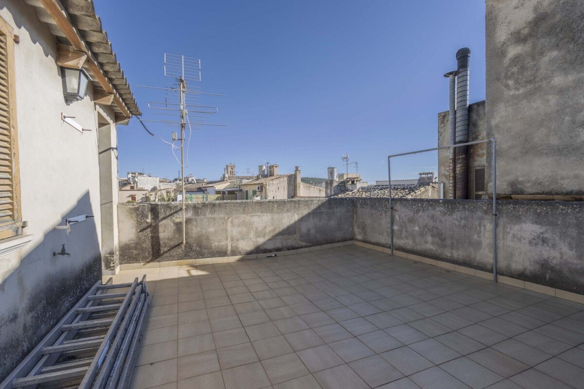 A rooftop with a ladder and antennas on it