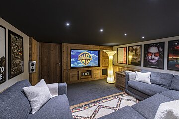 A living room with a couch and a screen that says wb on it