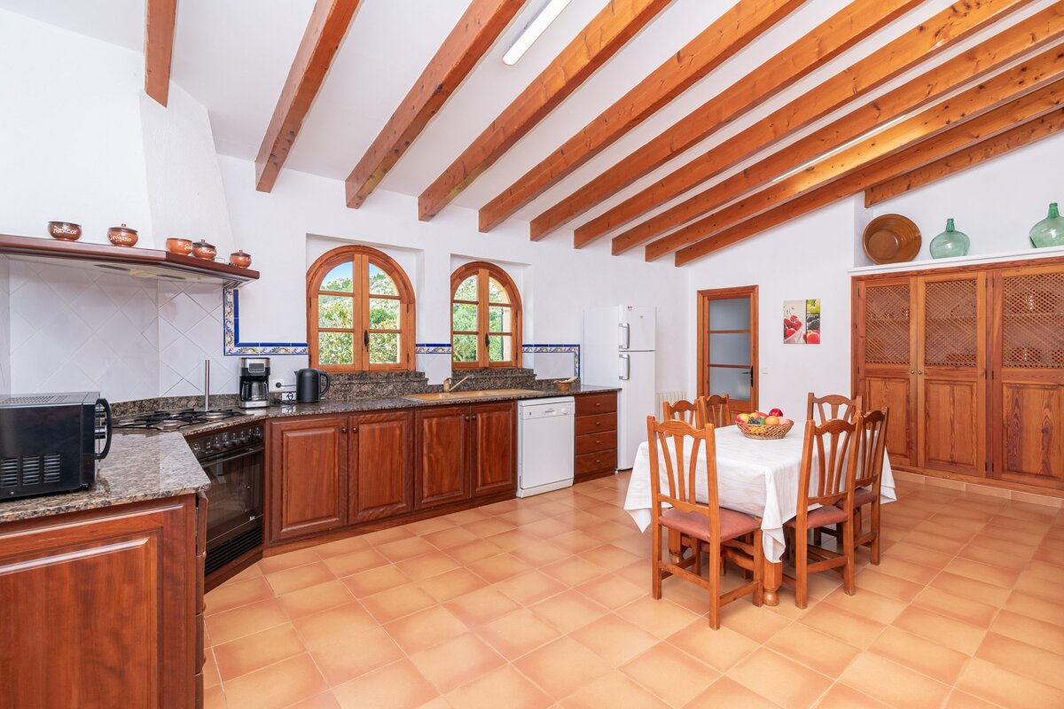 A kitchen with a table and chairs and a microwave