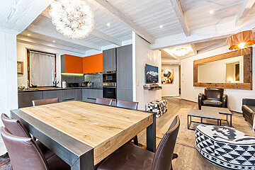 A living room with a wooden table and chairs