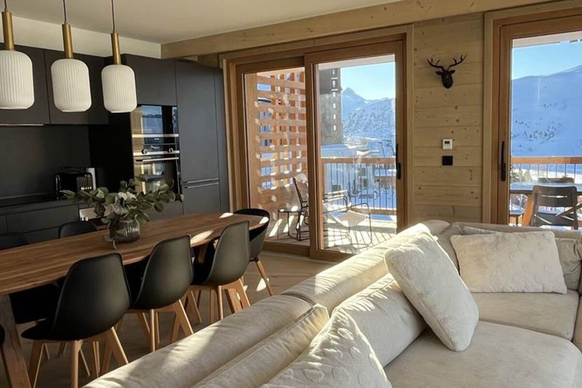 A living room with a couch and a table and chairs