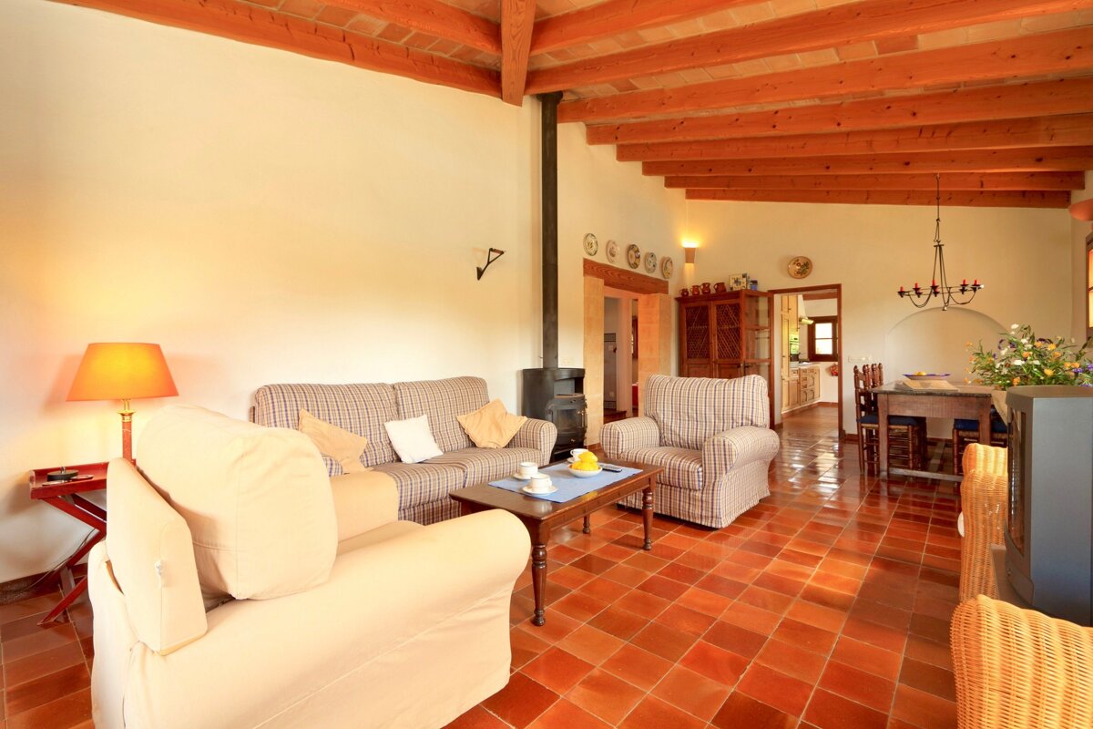 A living room with a couch and two chairs
