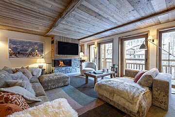 A living room with a fireplace and a flat screen tv