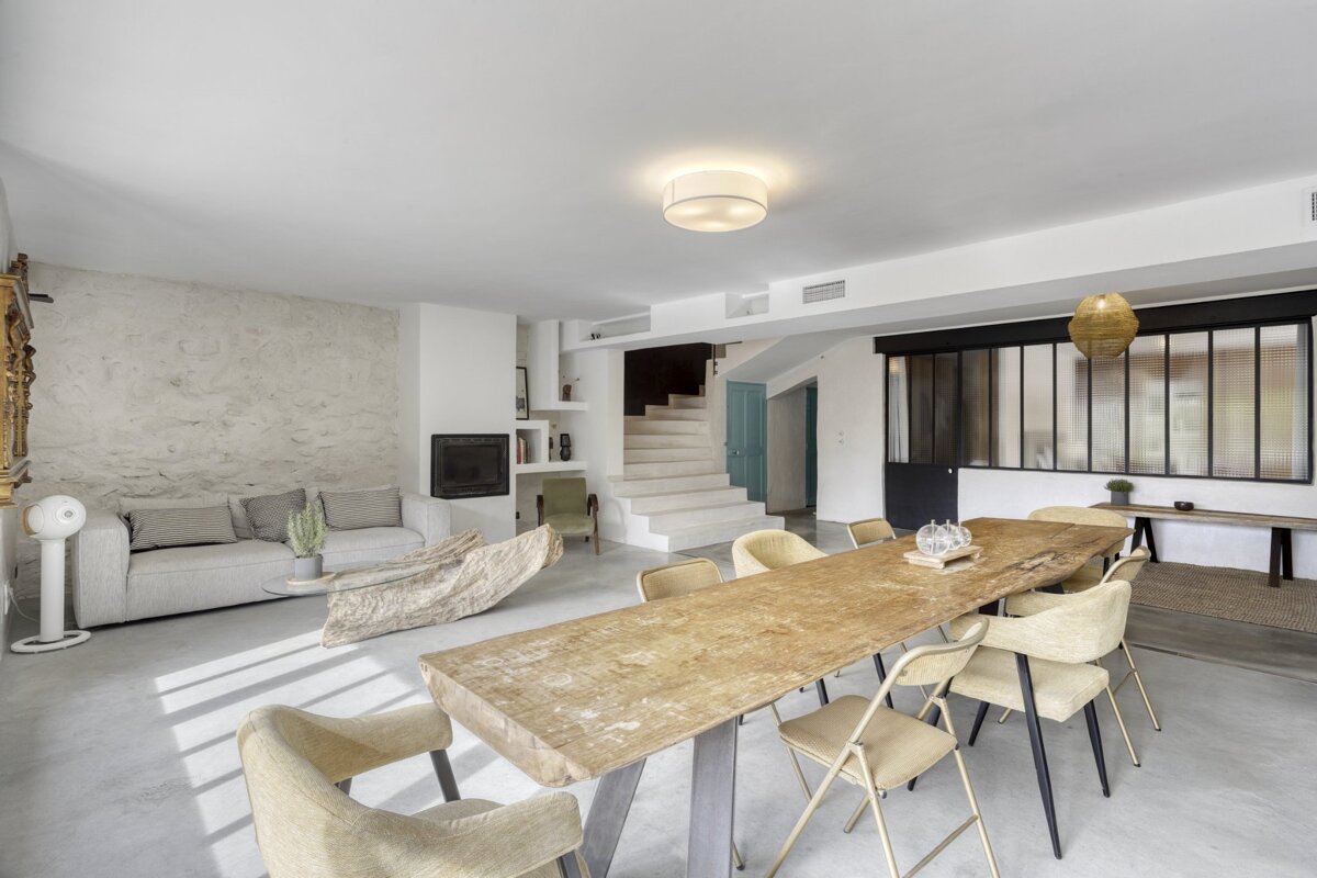 A living room with a dining table and chairs