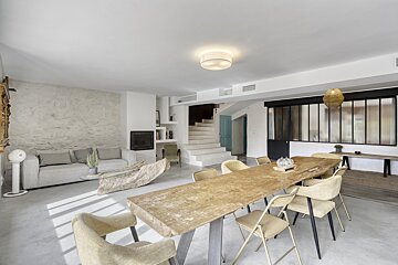 A living room with a dining table and chairs