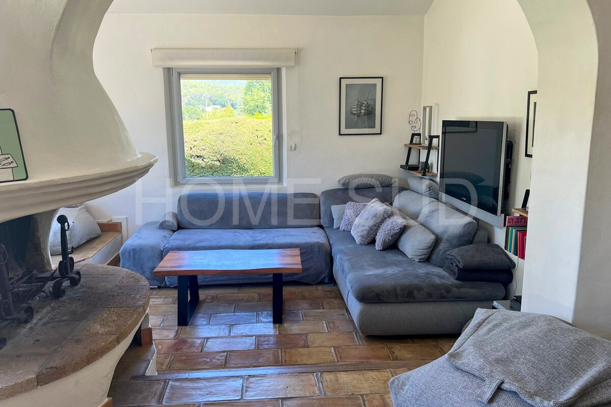 A living room with a couch and a television and the word home on the wall