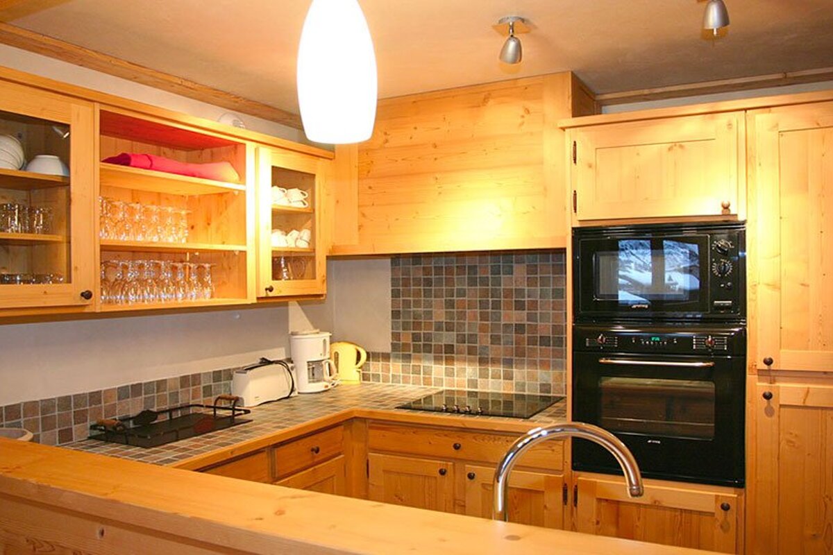 A kitchen with a stove top oven and a microwave