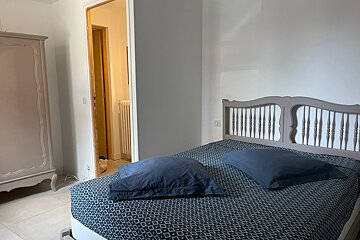 A bedroom with a bed and two pillows on it