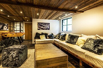 A living room filled with furniture and a foosball table