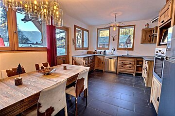A kitchen with cowhide chairs and a table