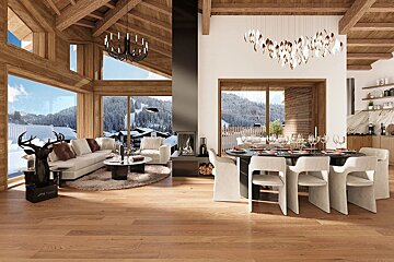 A luxurious, open-plan wooden chalet with living/dining areas, a modern fireplace, and stunning snowy mountain views through expansive windows.