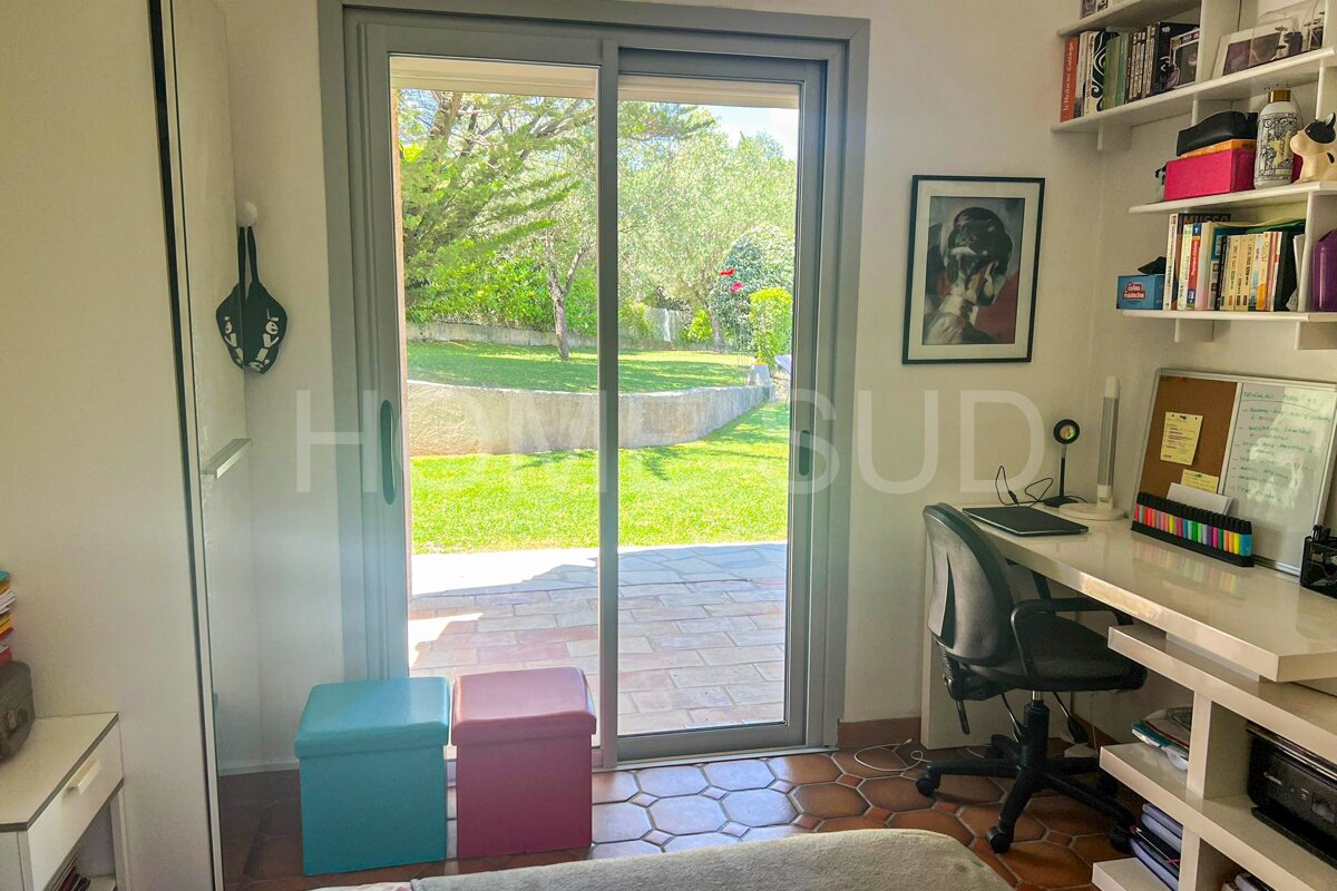 A room with a sliding glass door that says home bud