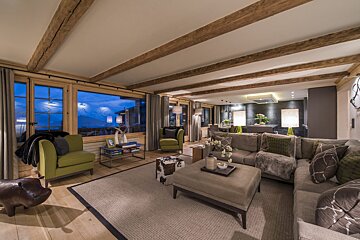 A living room with a couch and two chairs