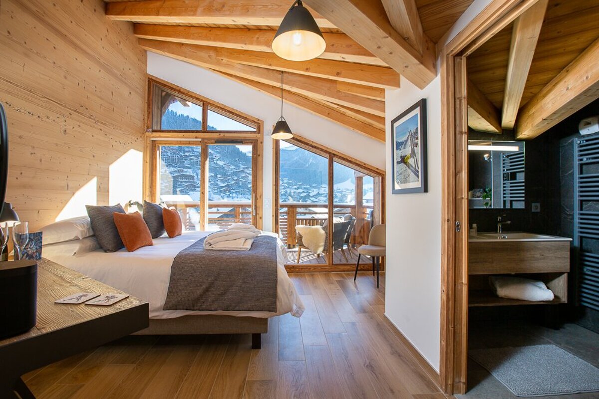 A bedroom with a large bed and a large window