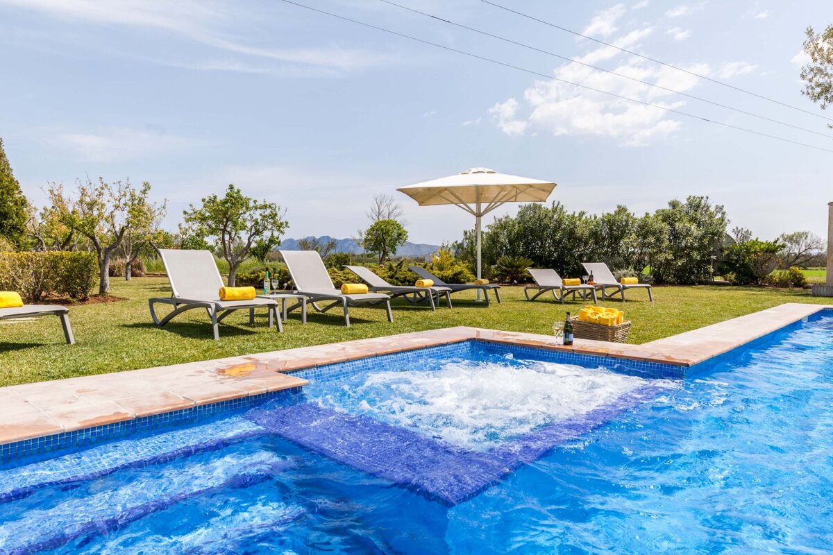 A large swimming pool with a jacuzzi in the middle