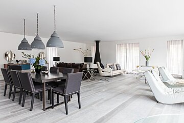 A living room with a dining table and chairs