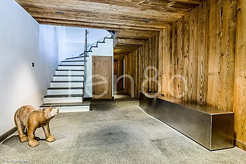 A statue of a bear stands in a hallway next to a staircase