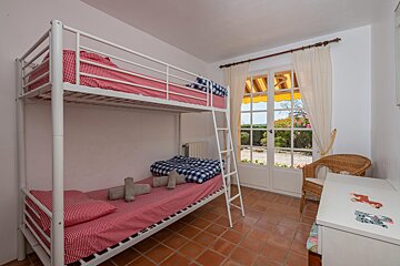 A bunk bed with a ladder in a bedroom