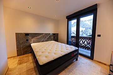 A bed with a mattress that says bedtime on it