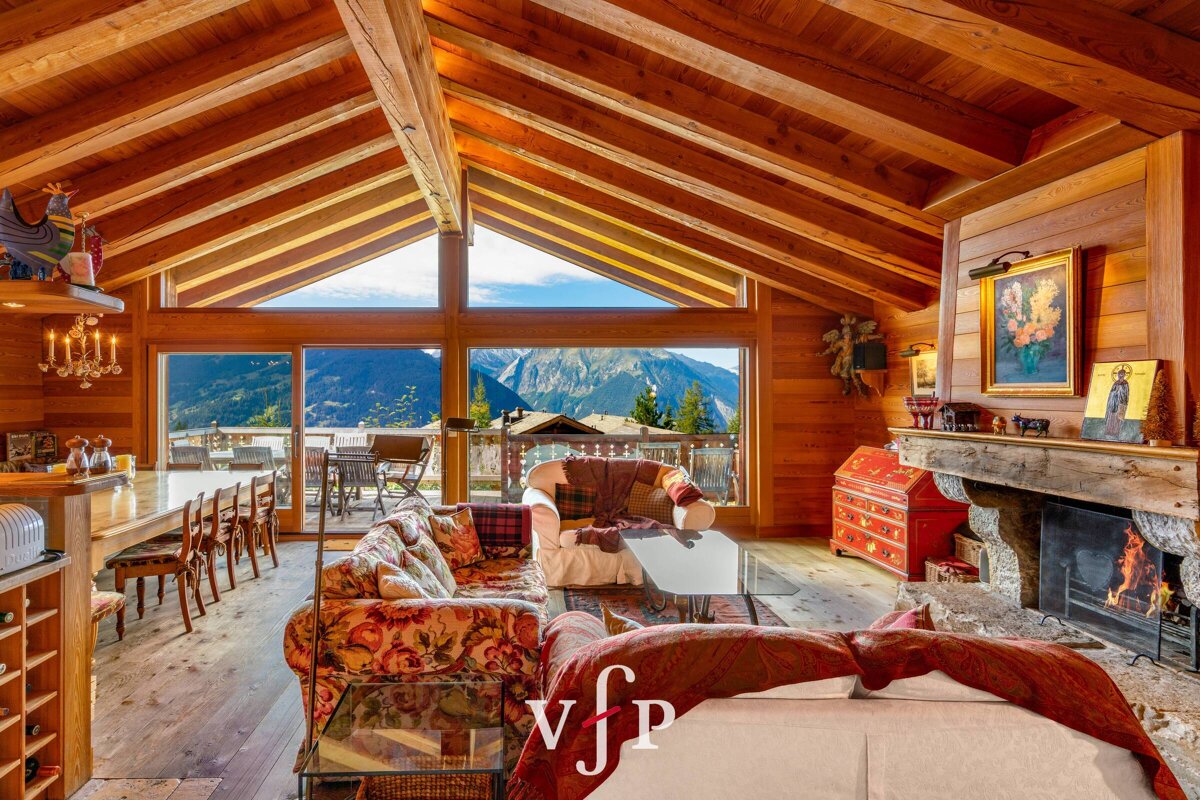 A living room with a couch and a fireplace with the letters vfp on the bottom