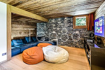 A living room with a stone wall and a tv that says holidays