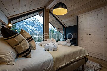 A bedroom with a large window and a sign that says reno