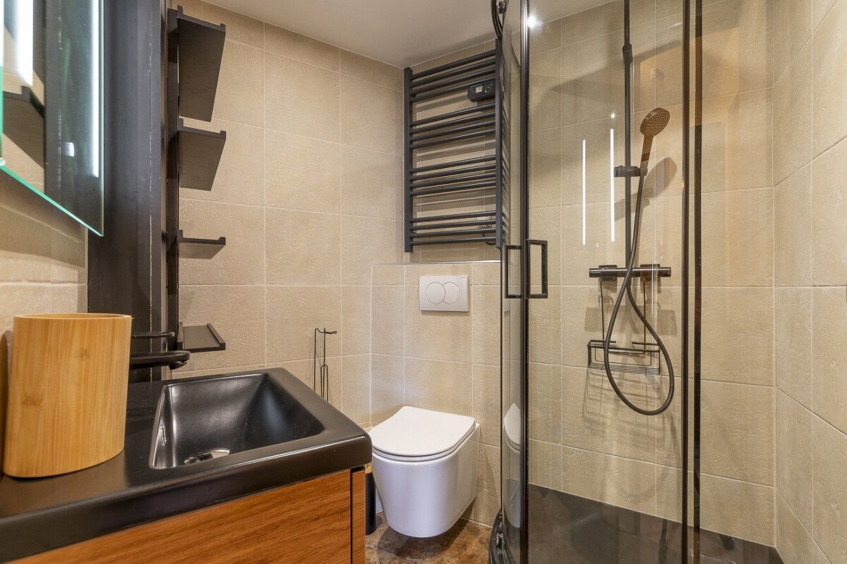 A bathroom with a toilet a sink and a shower